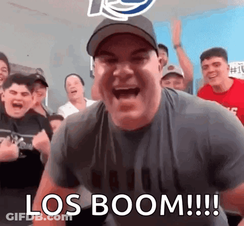 A Man Is Screaming In Front Of A Group Of People With The Words Los Boom Written On The Bottom . GIF