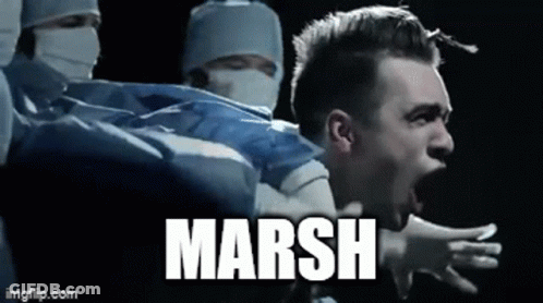 A Man Is Screaming In Front Of A Group Of Surgeons And The Word Marsh Is On The Bottom Of The Image . GIF