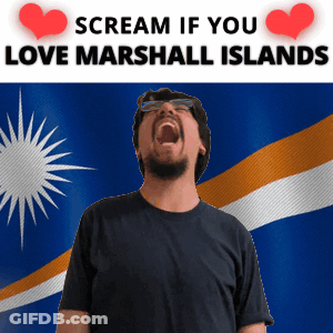 A Man Is Screaming In Front Of A Marshall Island Flag GIF