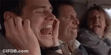 A Man Is Screaming While Sitting Next To Two Other Men . GIF