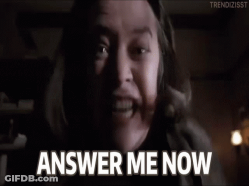 A Man Is Screaming With His Mouth Open And The Words `` Answer Me Now '' Written On The Screen . GIF