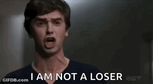A Man Is Screaming With His Mouth Open And The Words `` I Am Not A Loser '' . GIF