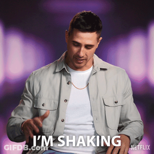 A Man Is Shaking His Shirt And Says I 'M Shaking On A Purple Background GIF