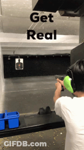 A Man Is Shooting A Gun In A Shooting Range With The Words Get Real Behind Him GIF