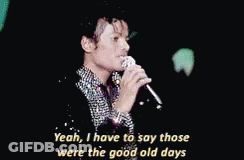 A Man Is Singing Into A Microphone And Saying Yeah I Have To Say Those Were The Good Old Days . GIF