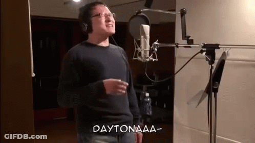 A Man Is Singing Into A Microphone In A Recording Studio And The Words Daytonaaa Are Above Him . GIF