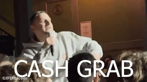 A Man Is Singing Into A Microphone In Front Of A Crowd With The Words Cash Grab Below Him GIF