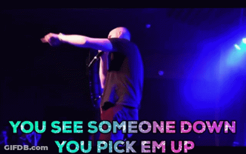 A Man Is Singing Into A Microphone On A Stage With The Words You See Someone Down You Pick Em Up GIF