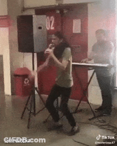 Man Singing Into Microphone With Keyboard GIF