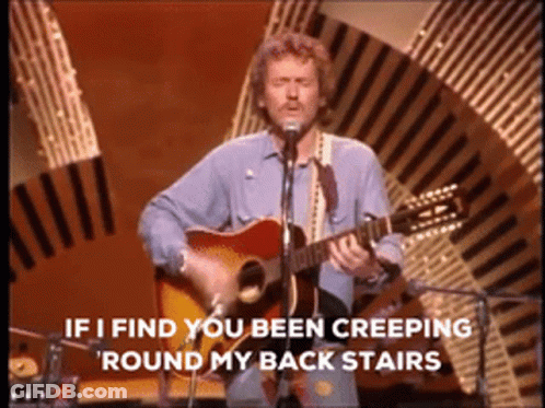 Man Singing Into Microphone With Guitar GIF