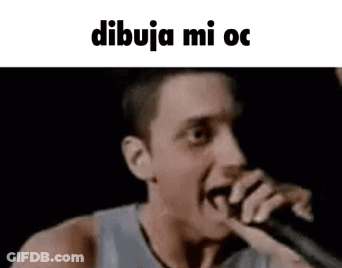 A Man Is Singing Into A Microphone With The Words Dibuja Mi Oc Written On The Bottom . GIF