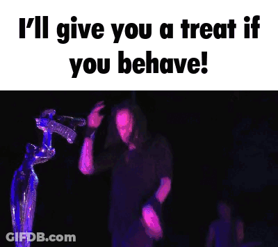 A Man Is Singing Into A Microphone With The Words I 'Ll Give You A Treat If You Behave GIF