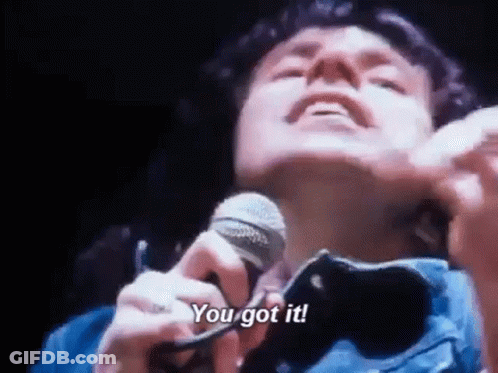 A Man Is Singing Into A Microphone With The Words `` You Got It '' . GIF