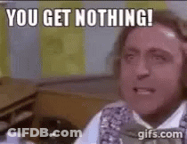 A Man Is Sitting At A Desk And Making A Funny Face . GIF