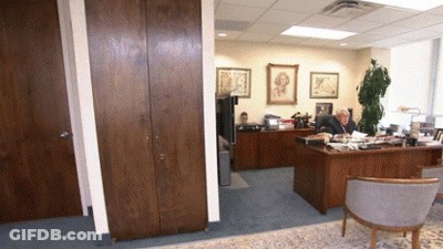 A Man Is Sitting At A Desk In An Office GIF