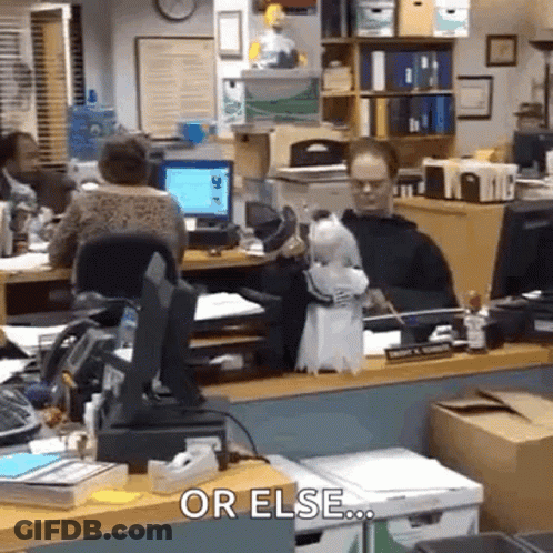 A Man Is Sitting At A Desk In An Office With A Parrot On His Desk . GIF