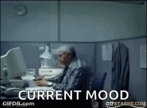 Man At Desk With Current Mood On Screen GIF