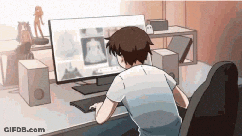 A Man Is Sitting At A Desk Looking At A Computer Monitor GIF