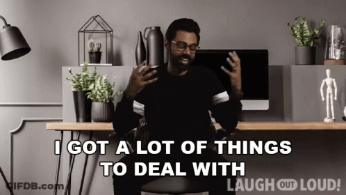 A Man Is Sitting At A Desk With A Computer And Says " I Got A Lot Of Things To Deal With " GIF
