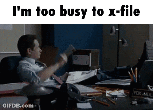 A Man Is Sitting At A Desk With His Feet Up And A Fox Mail Holder GIF
