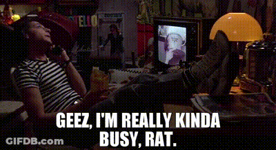 A Man Is Sitting At A Desk With His Feet Up And Talking On A Phone . GIF