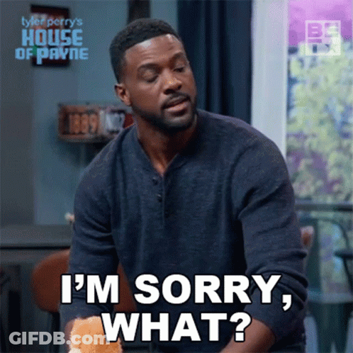 A Man Is Sitting At A Table And Saying I 'M Sorry , What ? GIF
