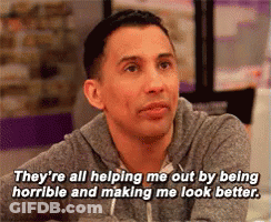 A Man Is Sitting At A Table And Says They 'Re All Helping Me Out By Being Horrible GIF
