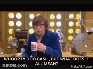 A Man Is Sitting At A Table Holding A Cup Of Coffee And Talking . GIF