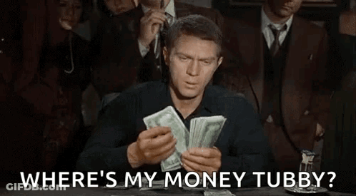A Man Is Sitting At A Table Holding A Pile Of Money And Asking Where 'S My Money Tubby . GIF