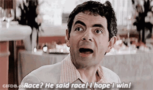 A Man Is Sitting At A Table In A Restaurant With His Mouth Open And Talking . GIF