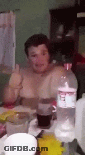 A Man Is Sitting At A Table With A Bottle Of Sprite On It GIF