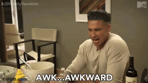 A Man Is Sitting At A Table With A Bottle Of Wine And Says Awkward . GIF