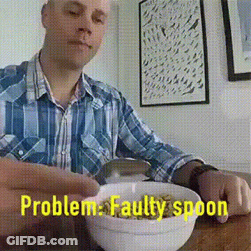 A Man Is Sitting At A Table With A Bowl Of Cereal And The Words Problem Faulty Spoon Behind Him GIF
