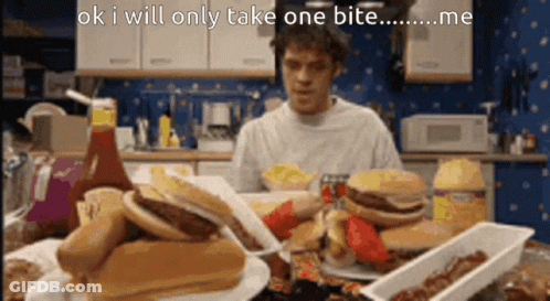 A Man Is Sitting At A Table With A Bunch Of Food And Says Ok I Will Only Take One Bite Me GIF