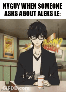 A Man Is Sitting At A Table With A Cup Of Coffee And A Cat On His Lap . GIF