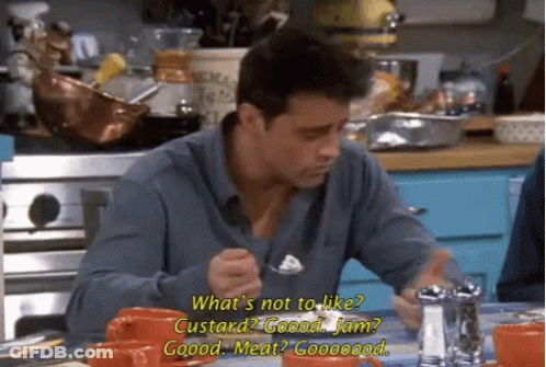 A Man Is Sitting At A Table With A Fork In His Hand . GIF