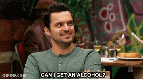 A Man Is Sitting At A Table With A Glass Of Wine And A Plate Of Food . GIF
