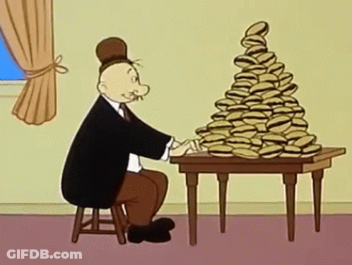 A Man Is Sitting At A Table With A Stack Of Hamburgers On It . GIF