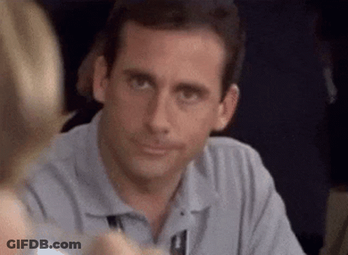 A Man Is Sitting At A Table With A Woman And Smiling . GIF