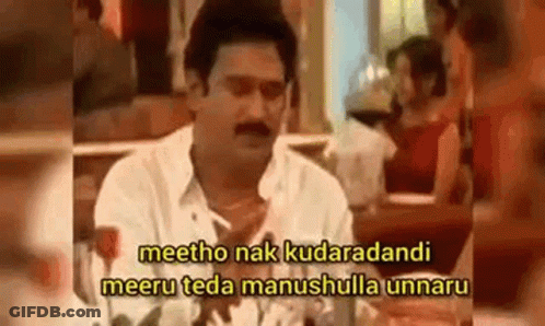 A Man Is Sitting At A Table With A Woman In A Restaurant And Talking To Her . GIF