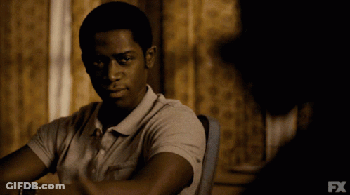 A Man Is Sitting At A Table With Fx Written On The Bottom GIF