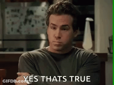 A Man Is Sitting At A Table With His Arms Crossed And The Words `` Yes That 'S True '' Written On The Screen . GIF