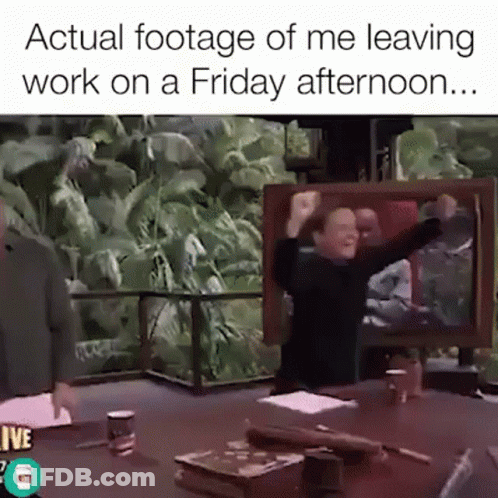 A Man Is Sitting At A Table With His Arms In The Air And A Caption That Says Actual Footage Of Me Leaving Work GIF