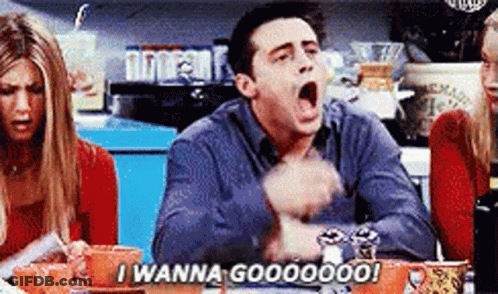 A Man Is Sitting At A Table With His Mouth Open And Saying I Wanna Goooooo ! GIF