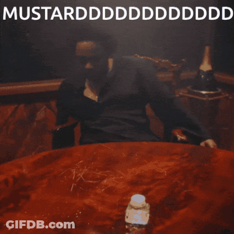 A Man Is Sitting At A Table With His Mouth Open And The Words Mustardddddddddddd On The Bottom GIF
