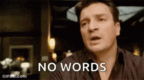 A Man Is Sitting At A Table With His Mouth Open And The Words `` No Words '' Written On His Face . GIF