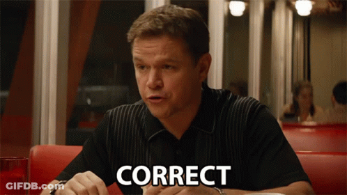 A Man Is Sitting At A Table With The Word Correct Written On His Face GIF