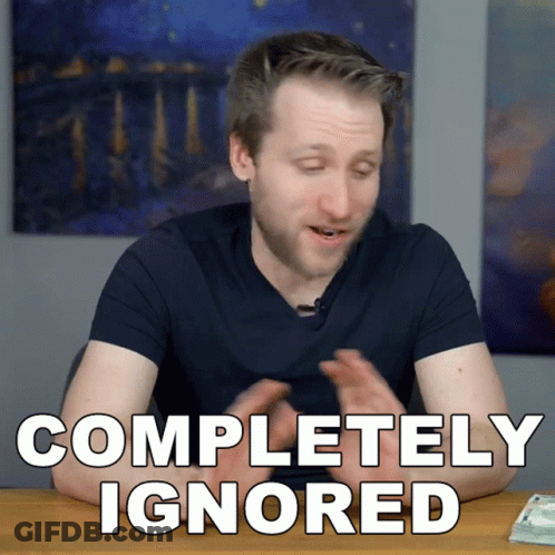 A Man Is Sitting At A Table With The Words Completely Ignored On The Screen GIF