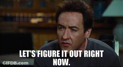 A Man Is Sitting At A Table With The Words `` Let 'S Figure It Out Right Now '' Written On The Screen . GIF
