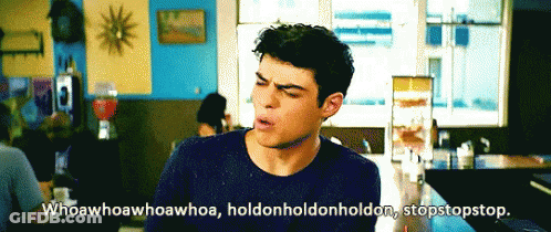 A Man Is Sitting At A Table With The Words Whoawhoawhoa Whoa Holdonholdon Holdon Stopstopstop GIF